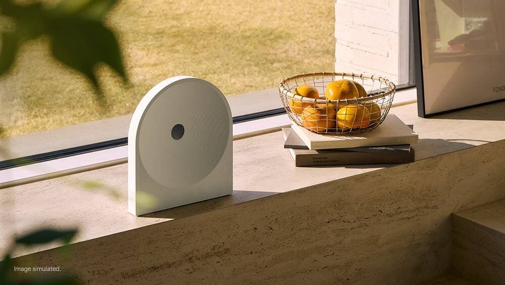 white Samsung Music Studio 5 device on a windowsill by a window