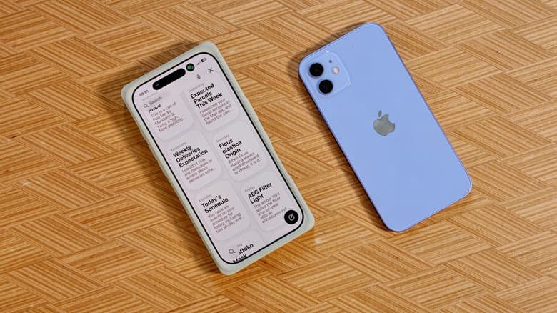 Two iPhones on a coffee table, one showing iOS 27's new Siri app.