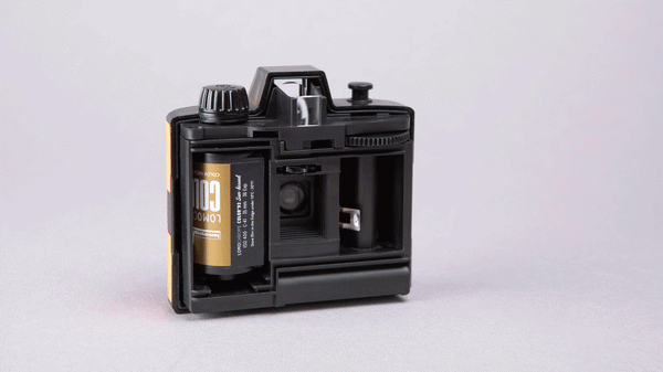 Animation of the Lomography Half-frame Simple Use Reloadable Film Camera with back open and different rolls of film being loaded