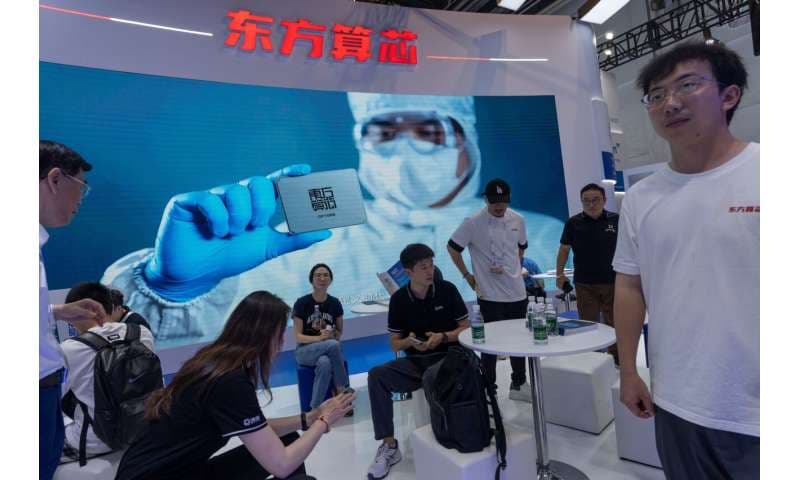 Visitors at the booth for Eastern Computing Chips, a Chinese AI semiconductor company, at the World AI Conference in Shanghai, Friday, July 17, 2026. Credit: AP Photo/Ng Han Guan