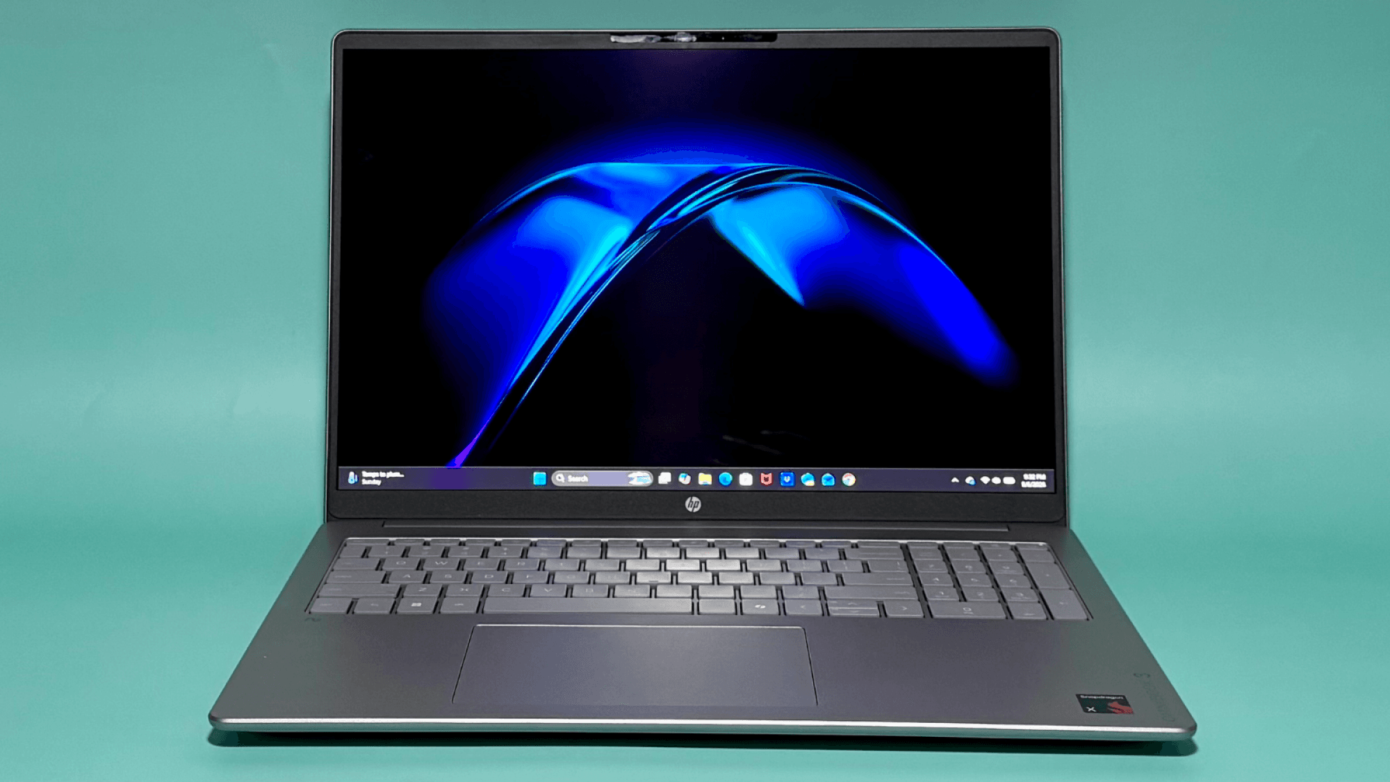 the hp omnibook 3 16 against an aqua background