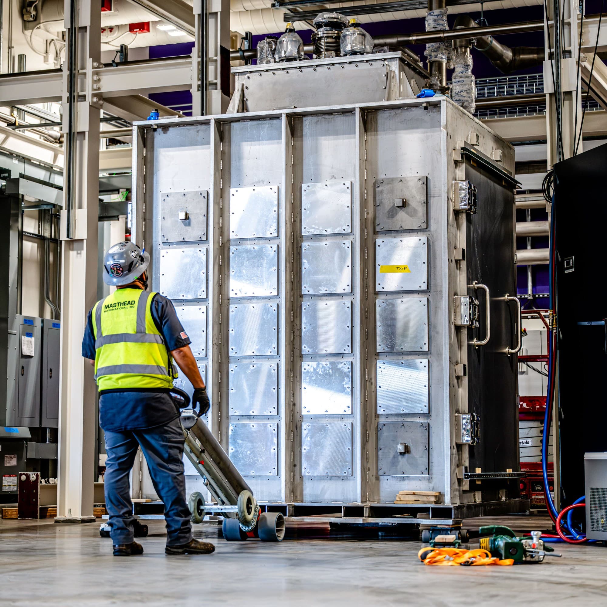 construction worker installing the Mk2.1 cabinet