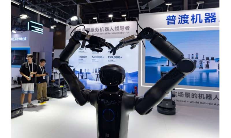 A robot from Pudu Robotics, a Chinese robotics company, welcomes visitors to the World AI Conference in Shanghai, Friday, July 17, 2026. Credit: AP Photo/Ng Han Guan